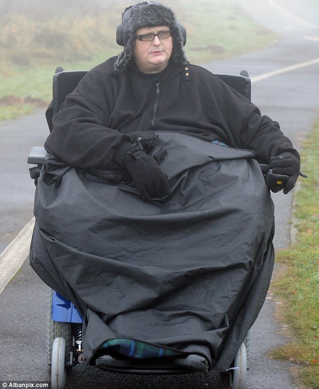 Mobile: Paul Mason sits in his motorised chair on a rare day out near his home in Ipswich after losing 20st