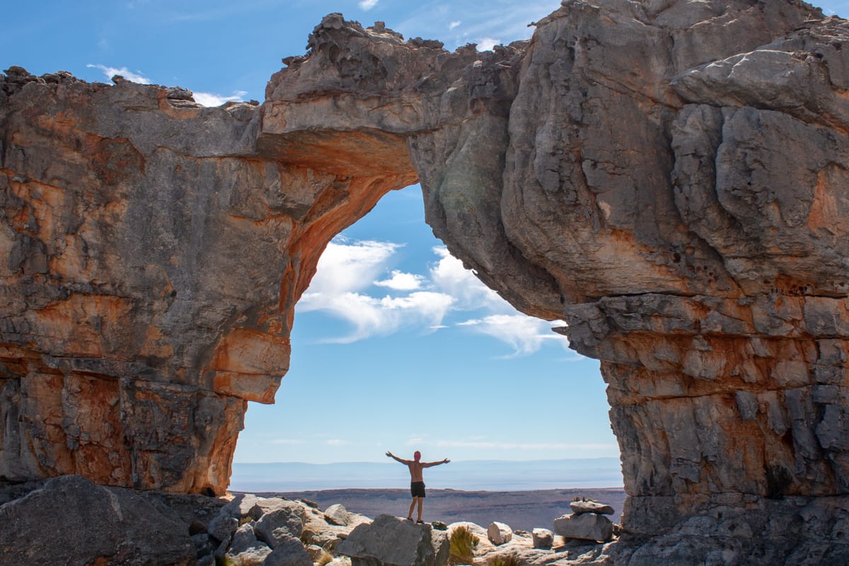 Prolonged fasting benefits cover image of Chris standing under Wolfberg Arch in South Africa